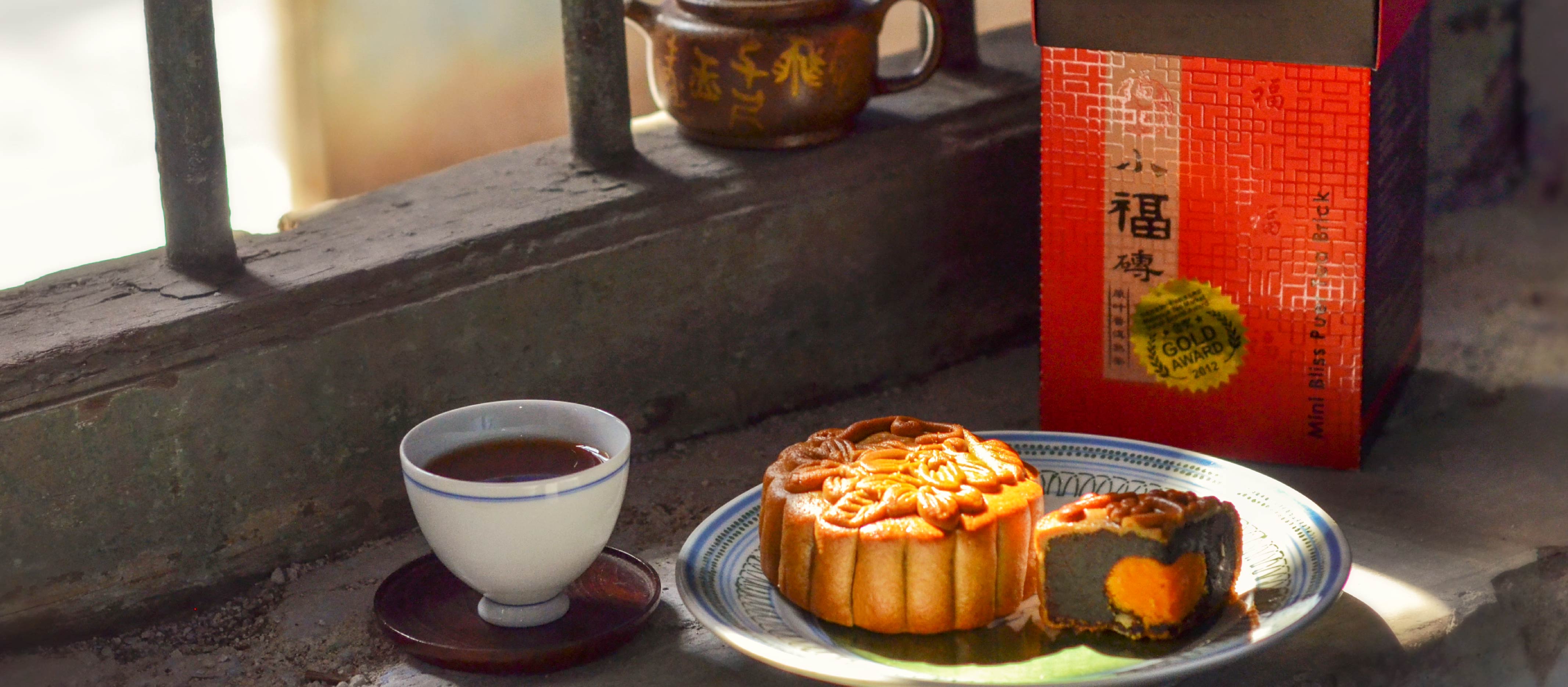 a mooncake pairing with ripe puerh tea beside windows