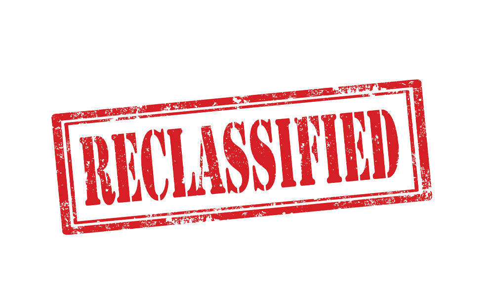 Stamp of the word "reclassified" on a white page