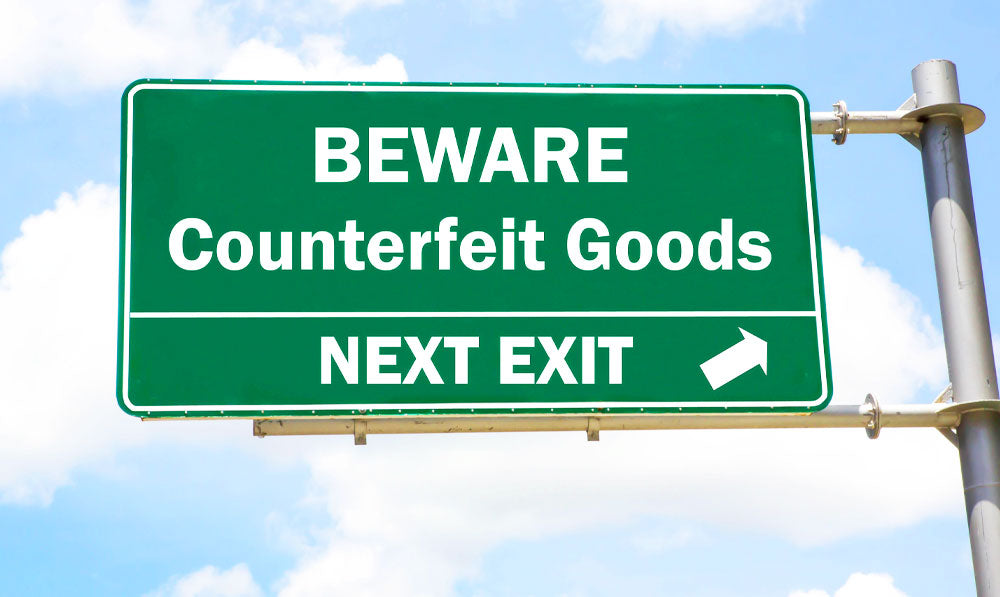 Highway sign saying beware of counterfeit products next exit