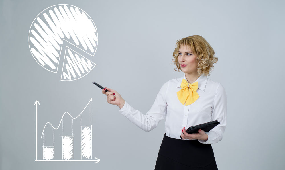 Woman pointing at charts against wall