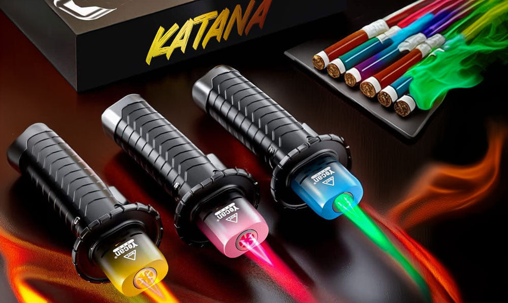 Yocan Katana Torch with flames on resting on dark surface with packaging nearby