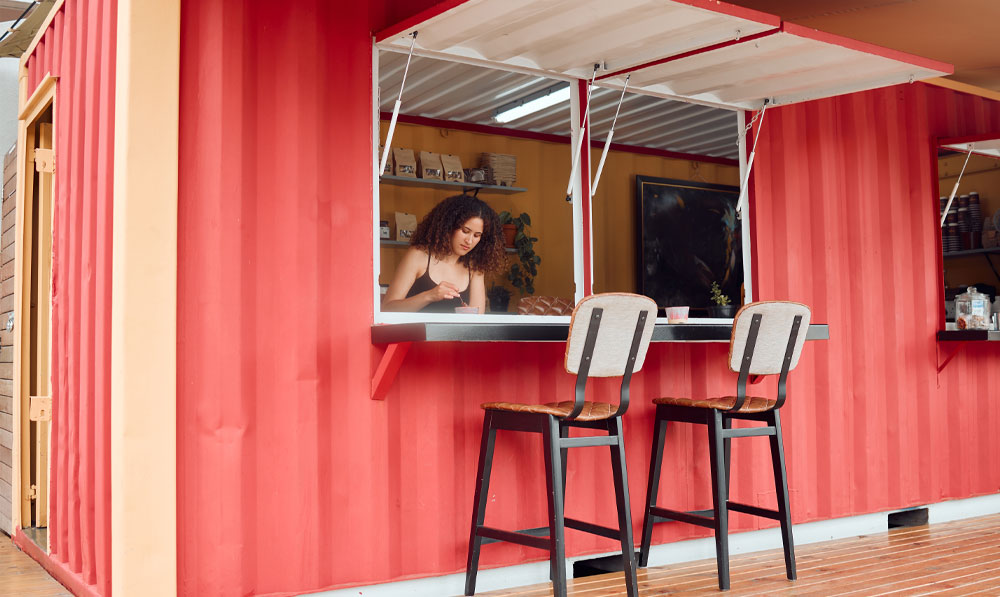 Woman working at a pink pop up shop