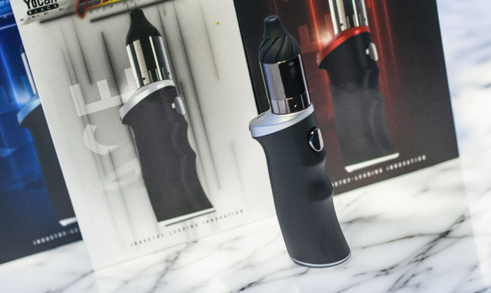 Yocan Black Phaser Ace standing on marble tabletop with packaging behind