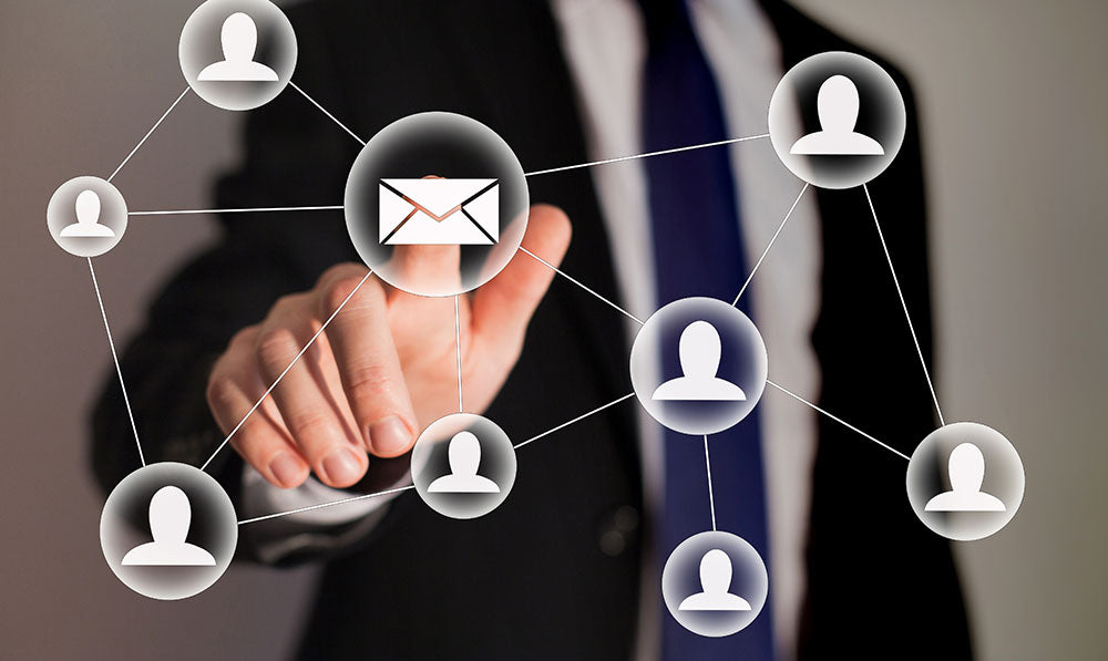 man in suit pressing floating email icon with other icons floating around