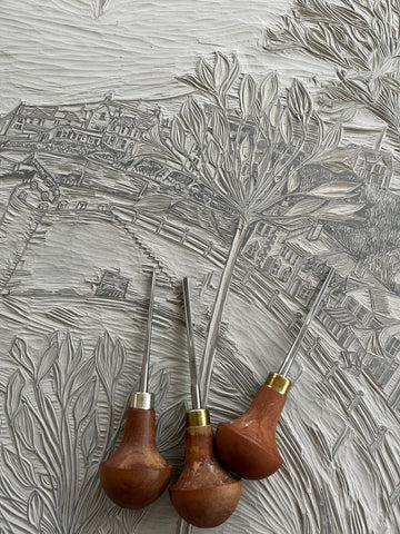 Detail of lino carving and tools of Porthleven harbour