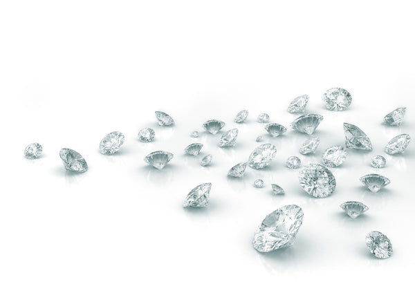 Photo of diamonds scattered on a white background.