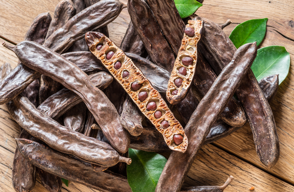 Image of carob seeds in a pod.