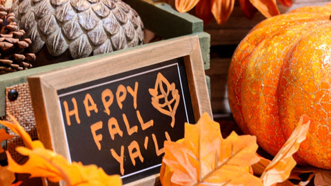 A sign that says 'Happy Fall Ya'll" with a pumpkin to the right. 