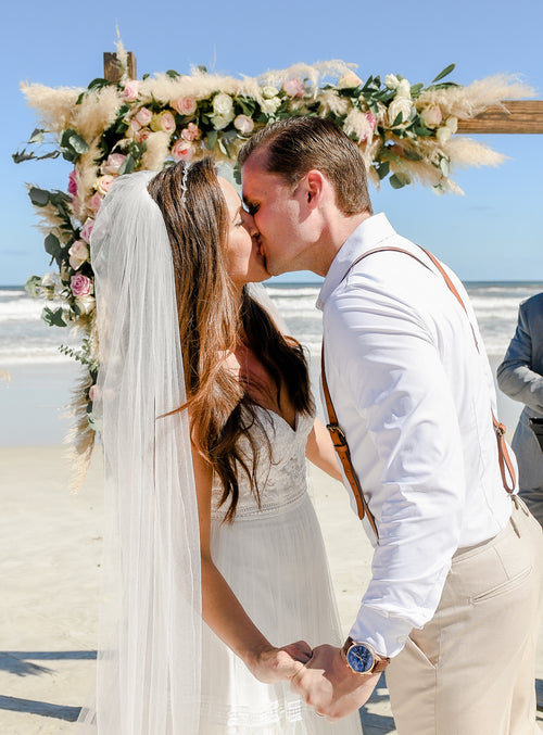 Me and my husband on our wedding day. Beach wedding with natural dried pampas grass decorations and pampas grass arch