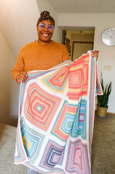 Toni Lipsey of TLYarnCrafts with her crochet Temperature Blanket