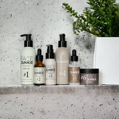 Picture of Face Junkie's Hero Collection on a concrete backdrop with plant pot and green accents in view