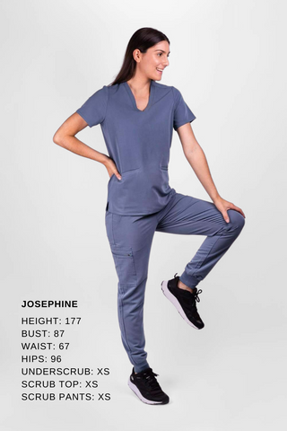 Healthcare worker demonstrates the fit of Dr. Woof Scrub tops and scrub pants.