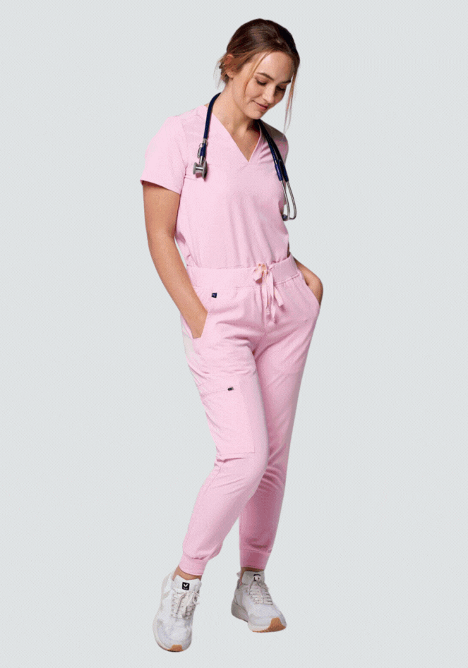 Person in pink scrubs with stethoscope around neck.