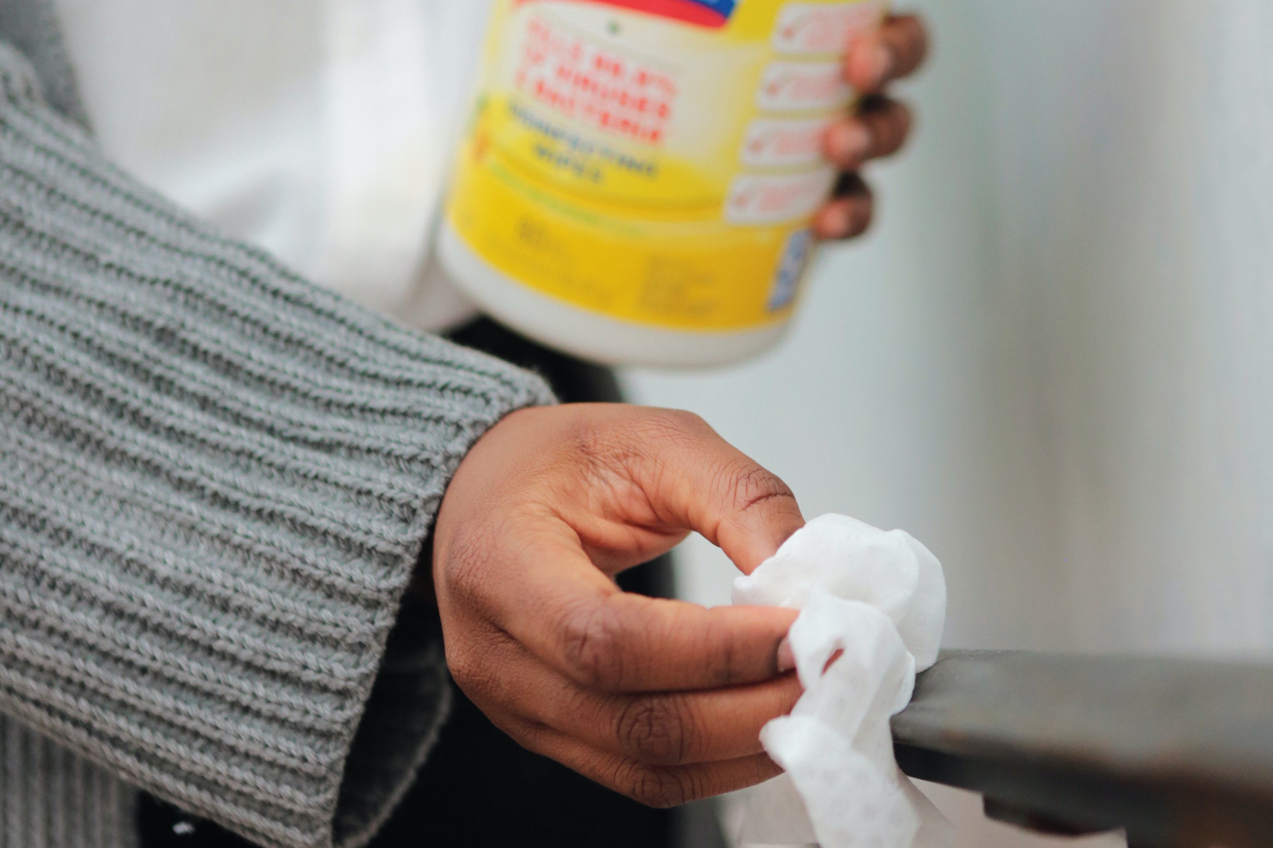 A Person Holding a Container of Wet Wipes