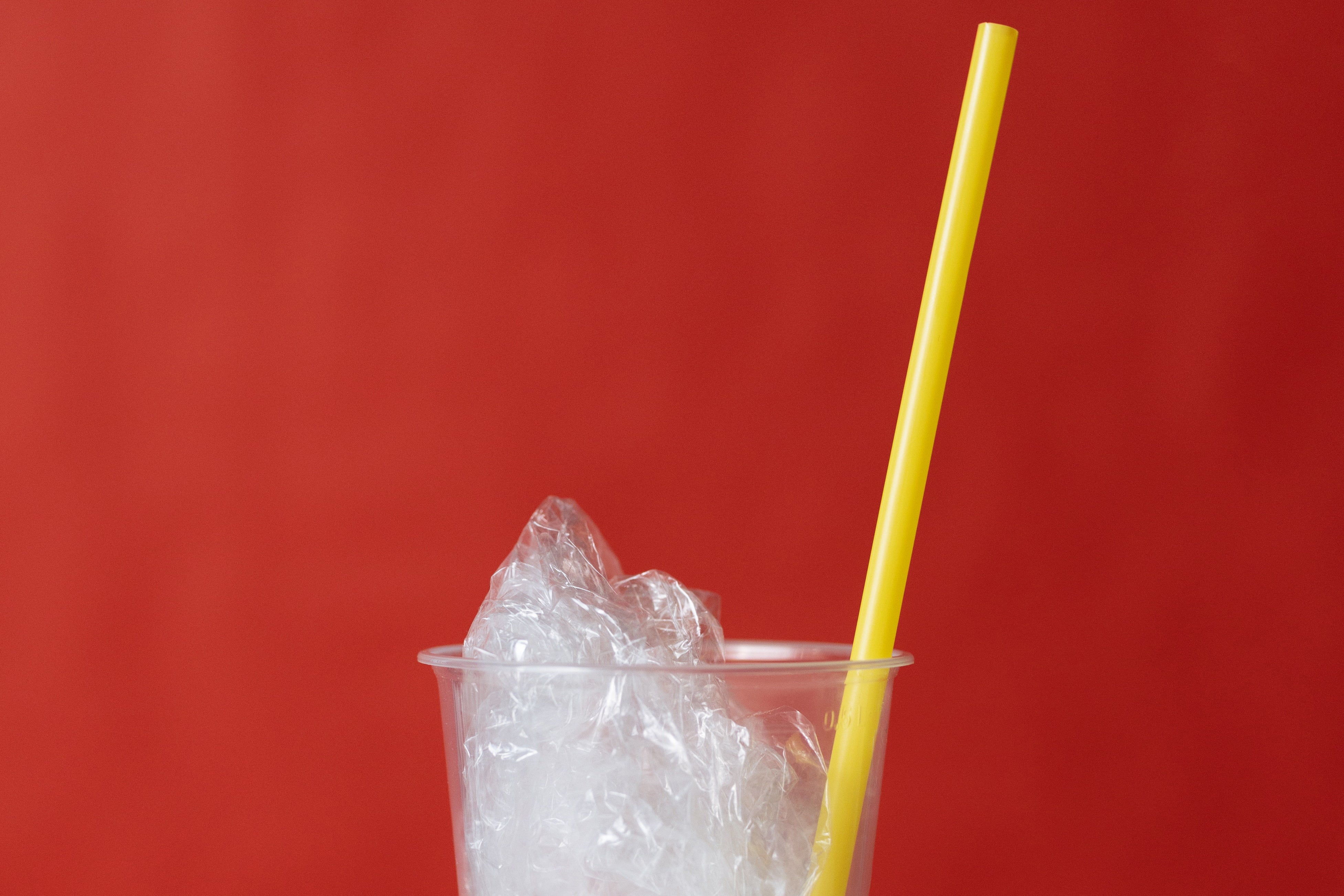 Clear Plastic Cup With Yellow Straw and Plastic