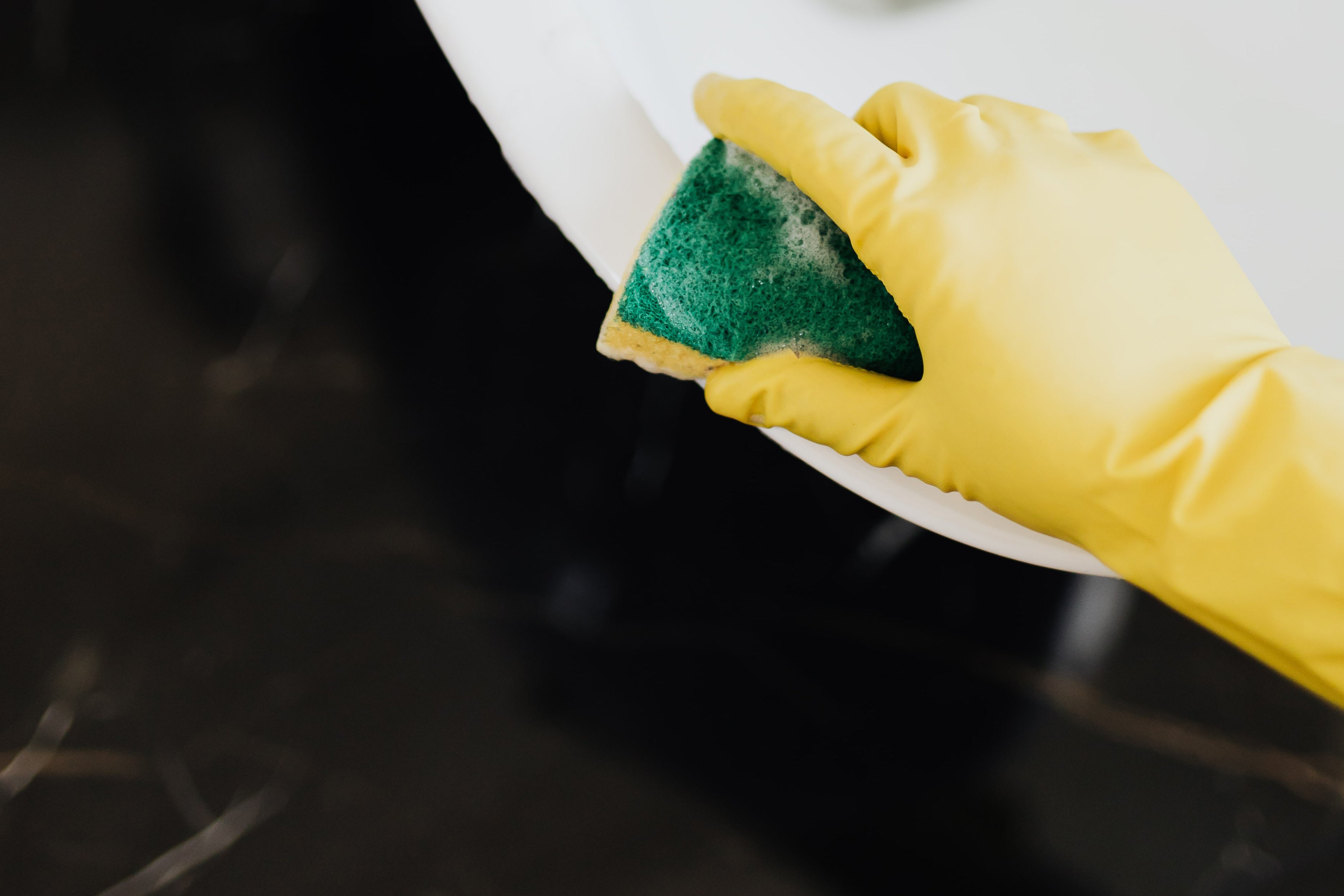 Crop of Person Cleaning Toilet Seat