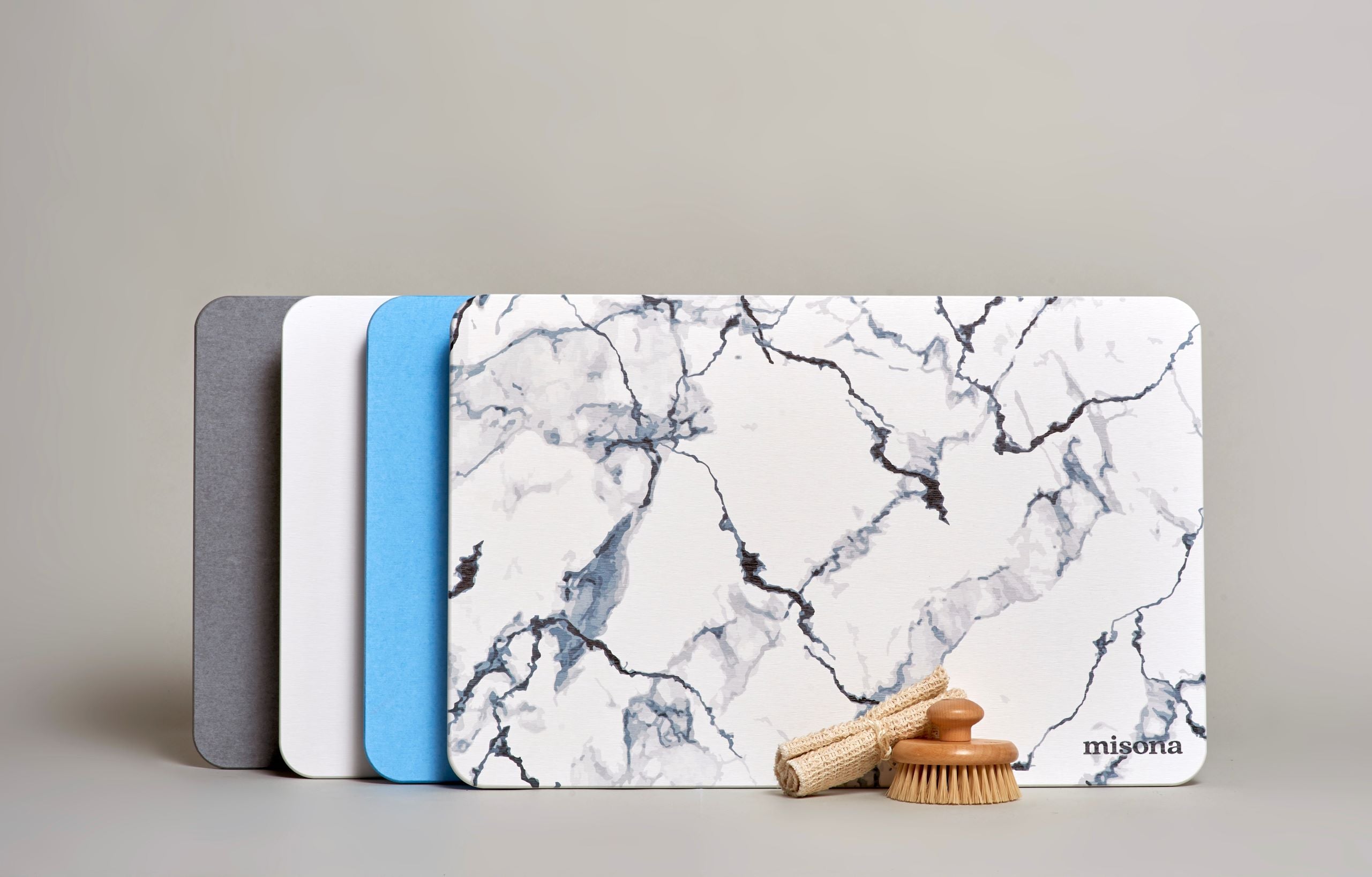 Diatomite Bath Mats stood up in four colours: Grey, Off White, Blue and Marble