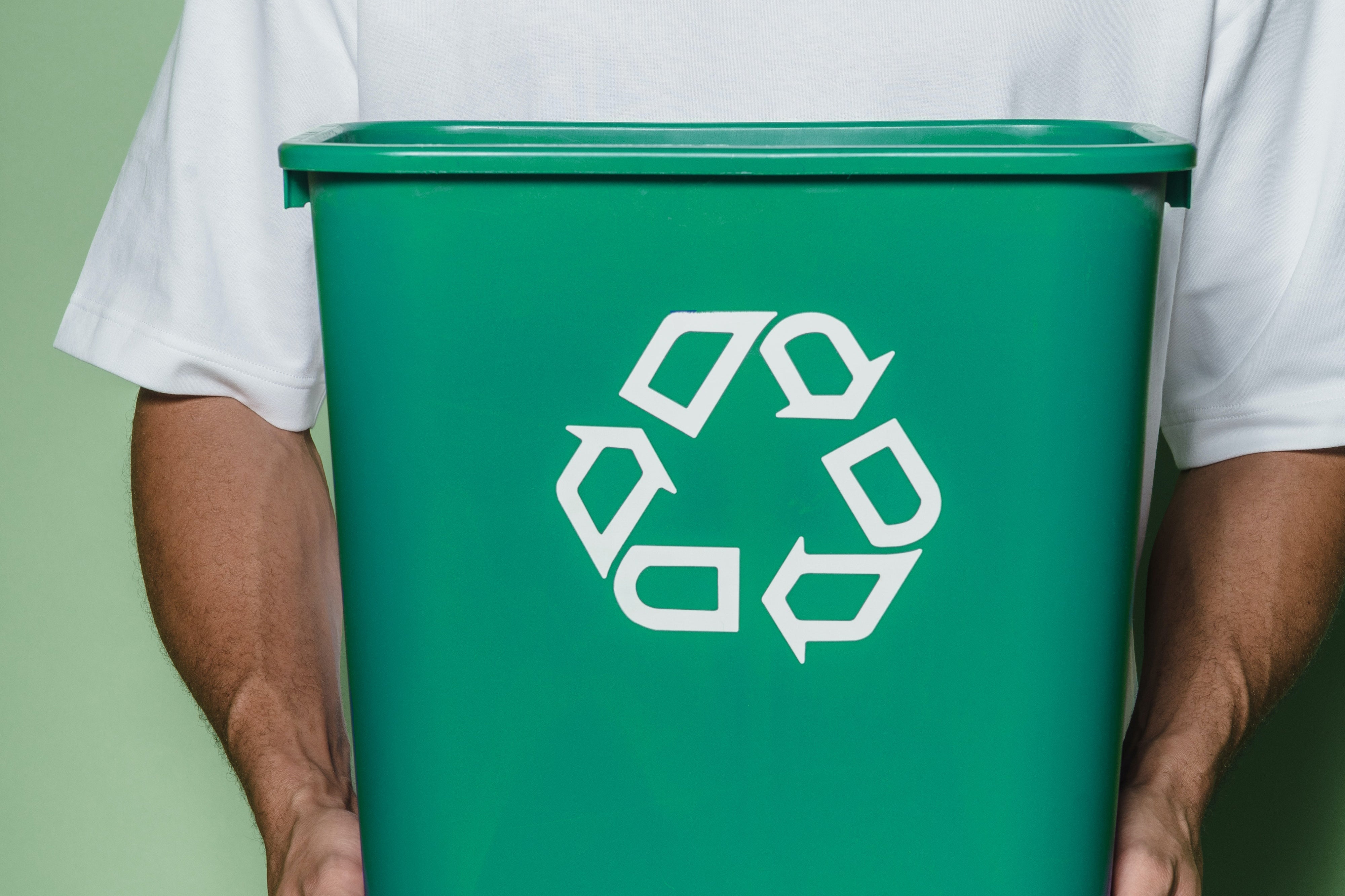 Man in White T-shirt Holding Green Recycling Box