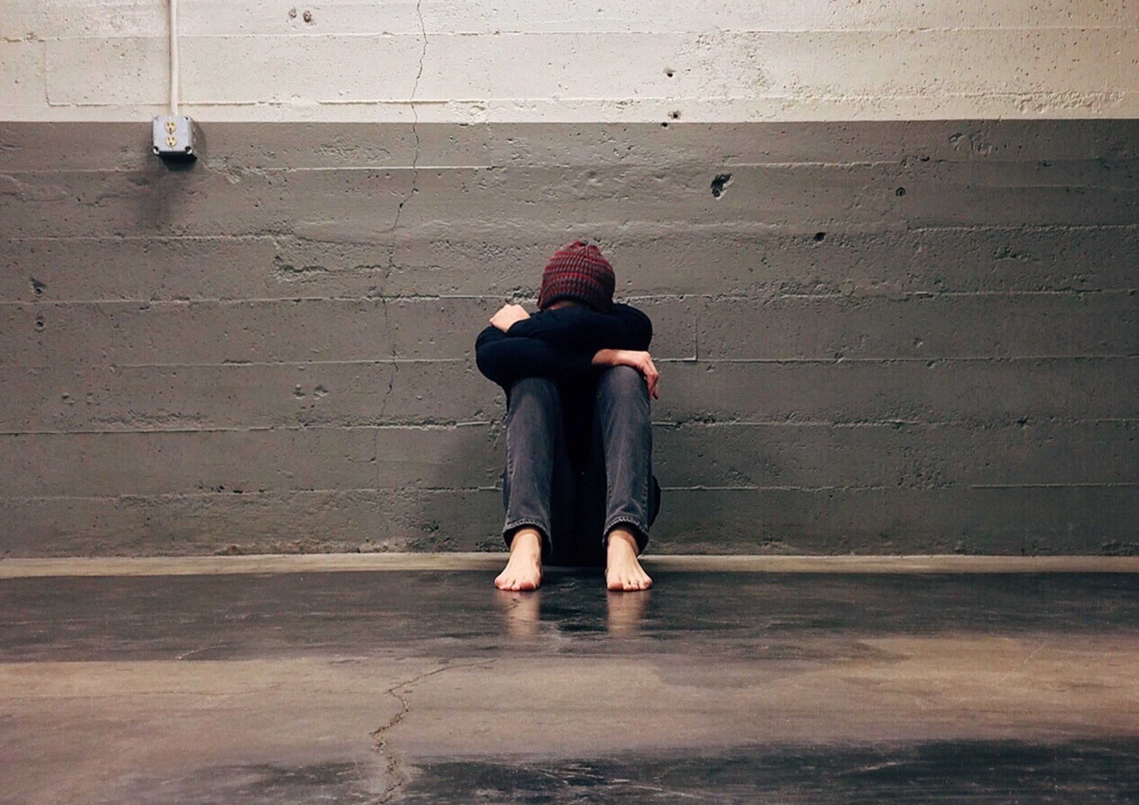 Person Leaning Against A Wall
