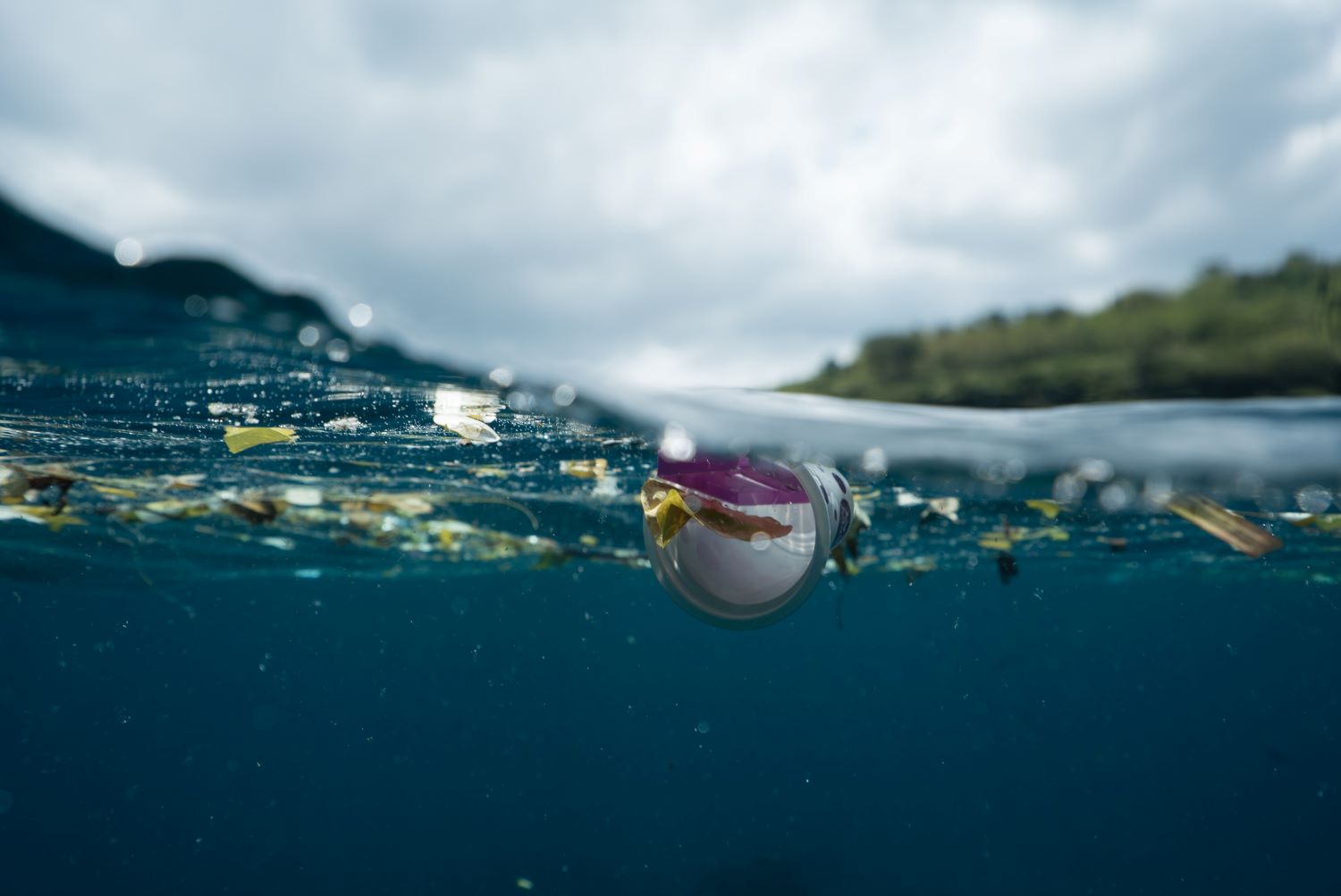 Rubbish floating in blue water of sea