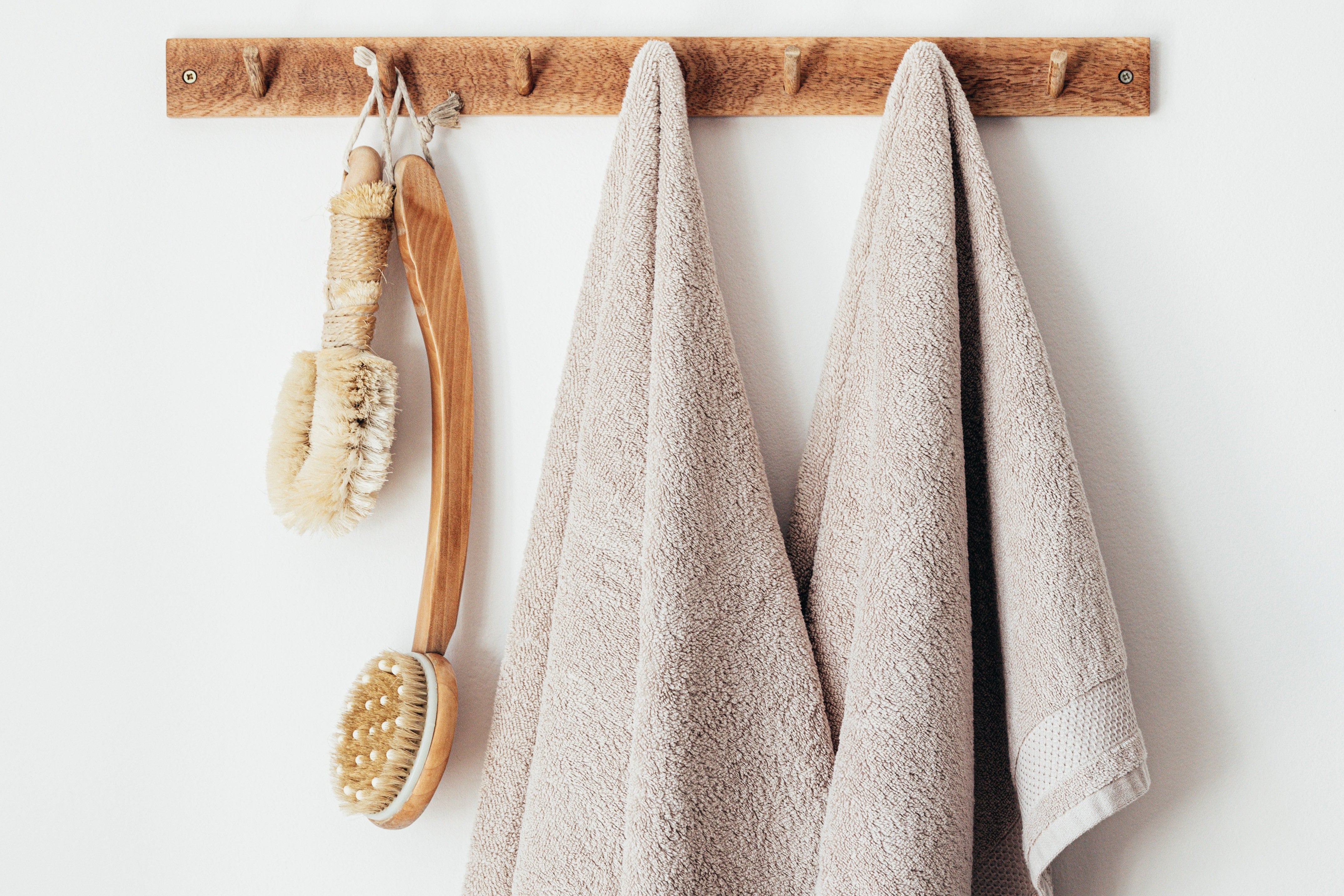 Wooden hanger with towels and body brushes