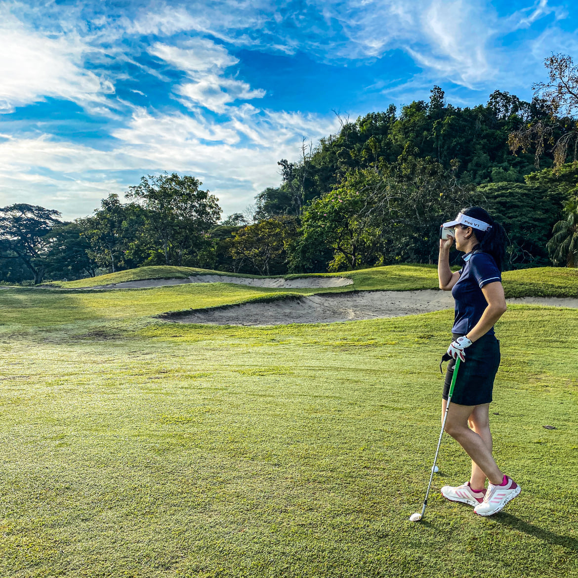 Female golfer on golf course | outdoor photography | blue skies