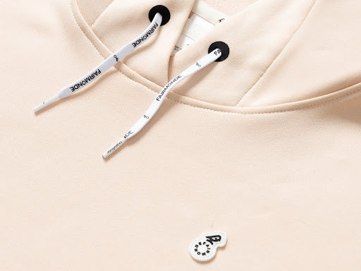 Shot of beige hoodie with white logo | Fairmonde Collective | WOmen golf hoodie
