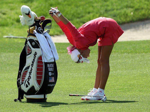 Natalie Gulbis stretching | white visor and sneakers | TaylorMade golf bag