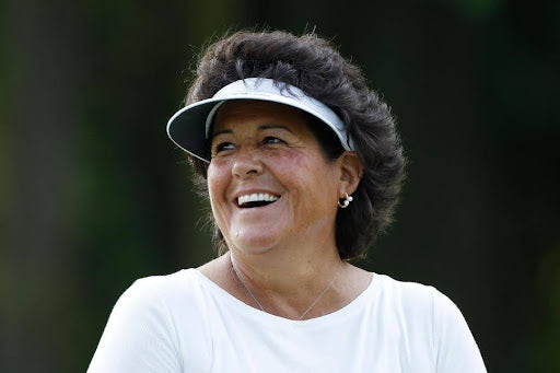 Nancy Lopez | female golfer | smiling | white sun visor