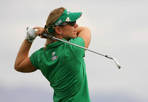Annika Sörenstam | women golf legend | swinging a golf club | wearing a green shirt and cap