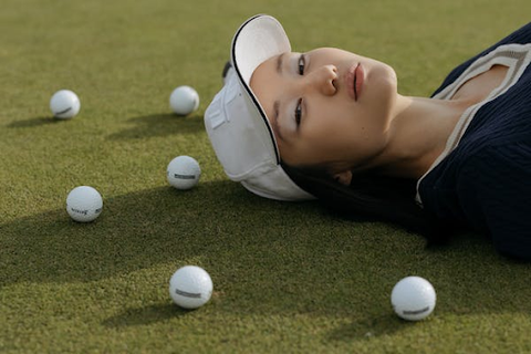 Golf course | Golf balls on the course | Asian women lying on the course
