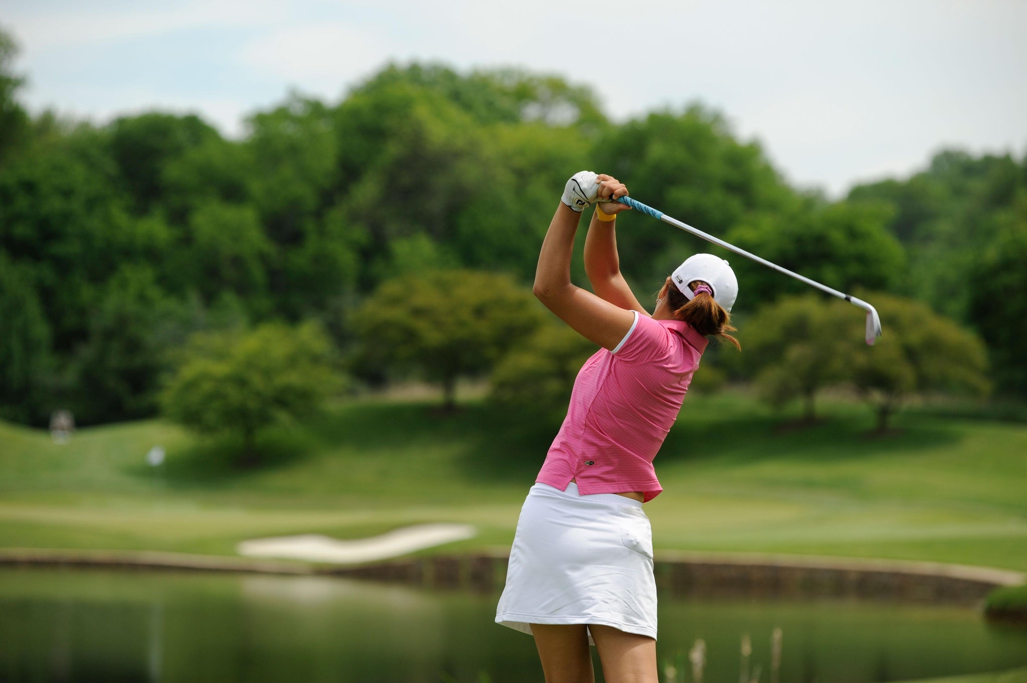 Professional female golfer | golf swing |golf club | pink golf top and white skirt