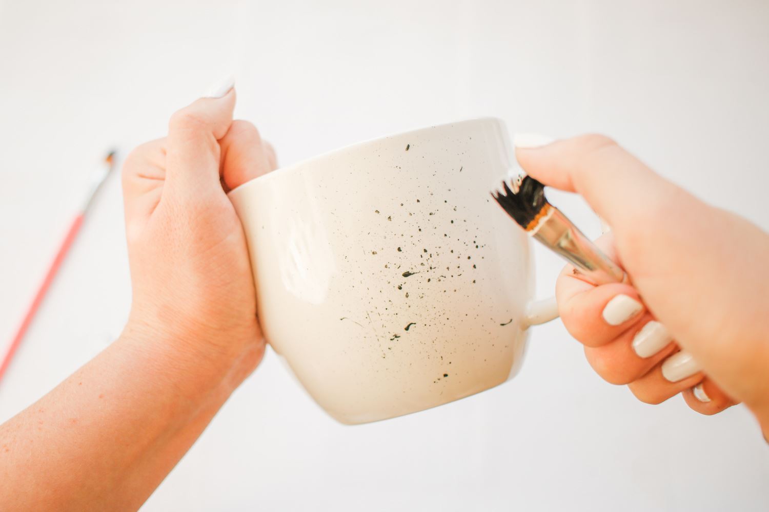 Splatter paint around the mug
