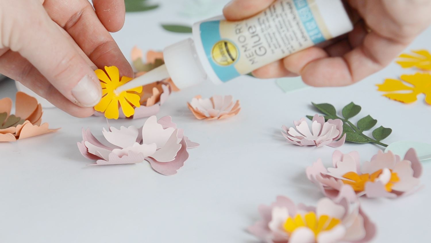 Begin gluing layers of flowers together