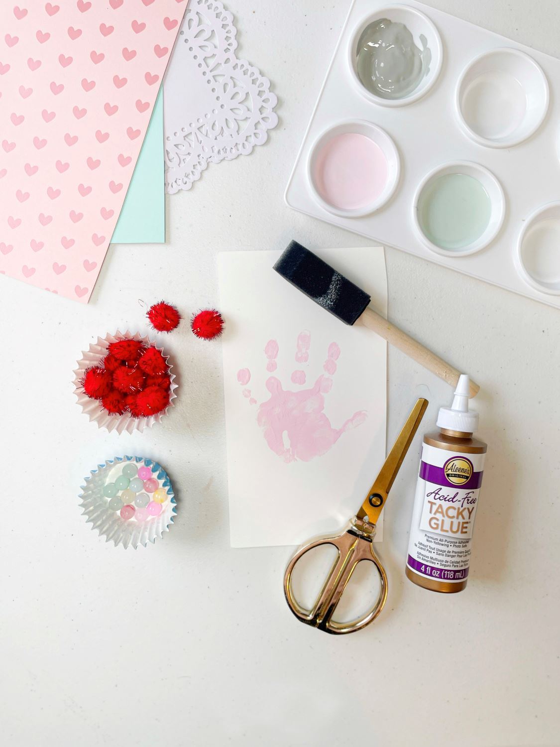 Press painted handprints onto white cardstock