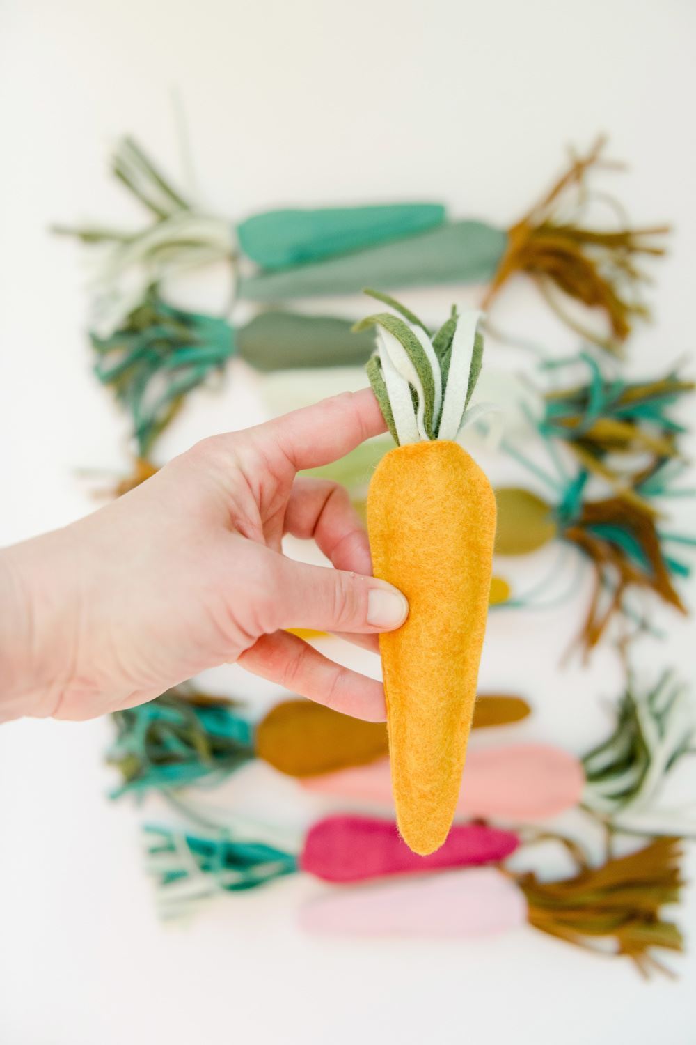 Insert carrot greenery to the top of carrot and press to secure