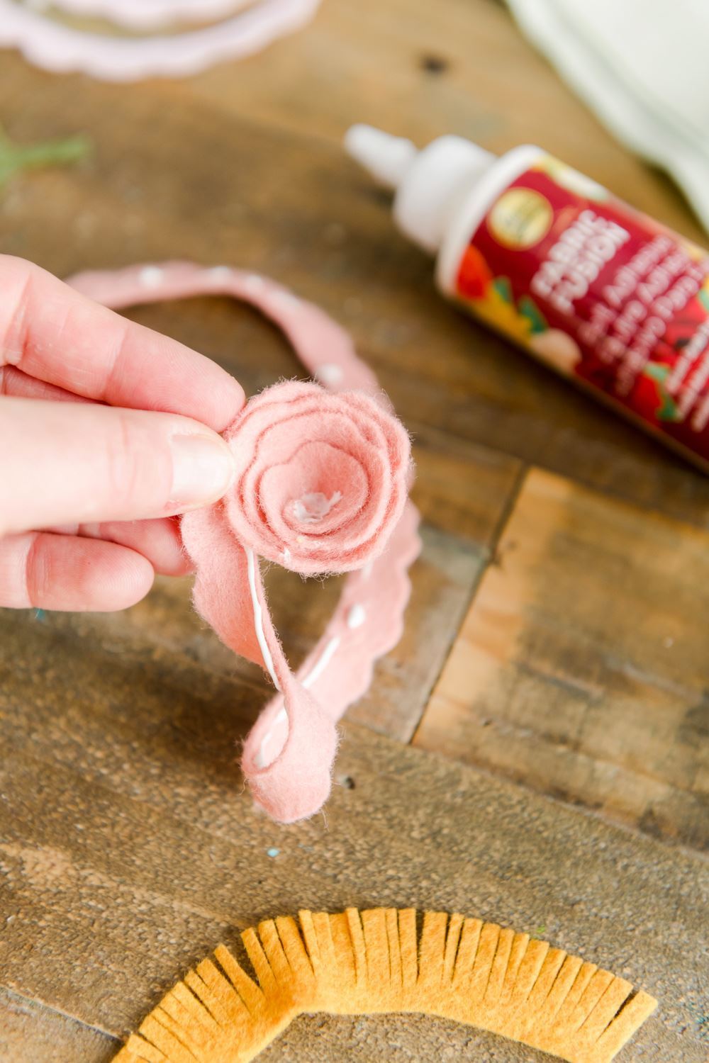 Apply fabric glue and roll to create felt flowers