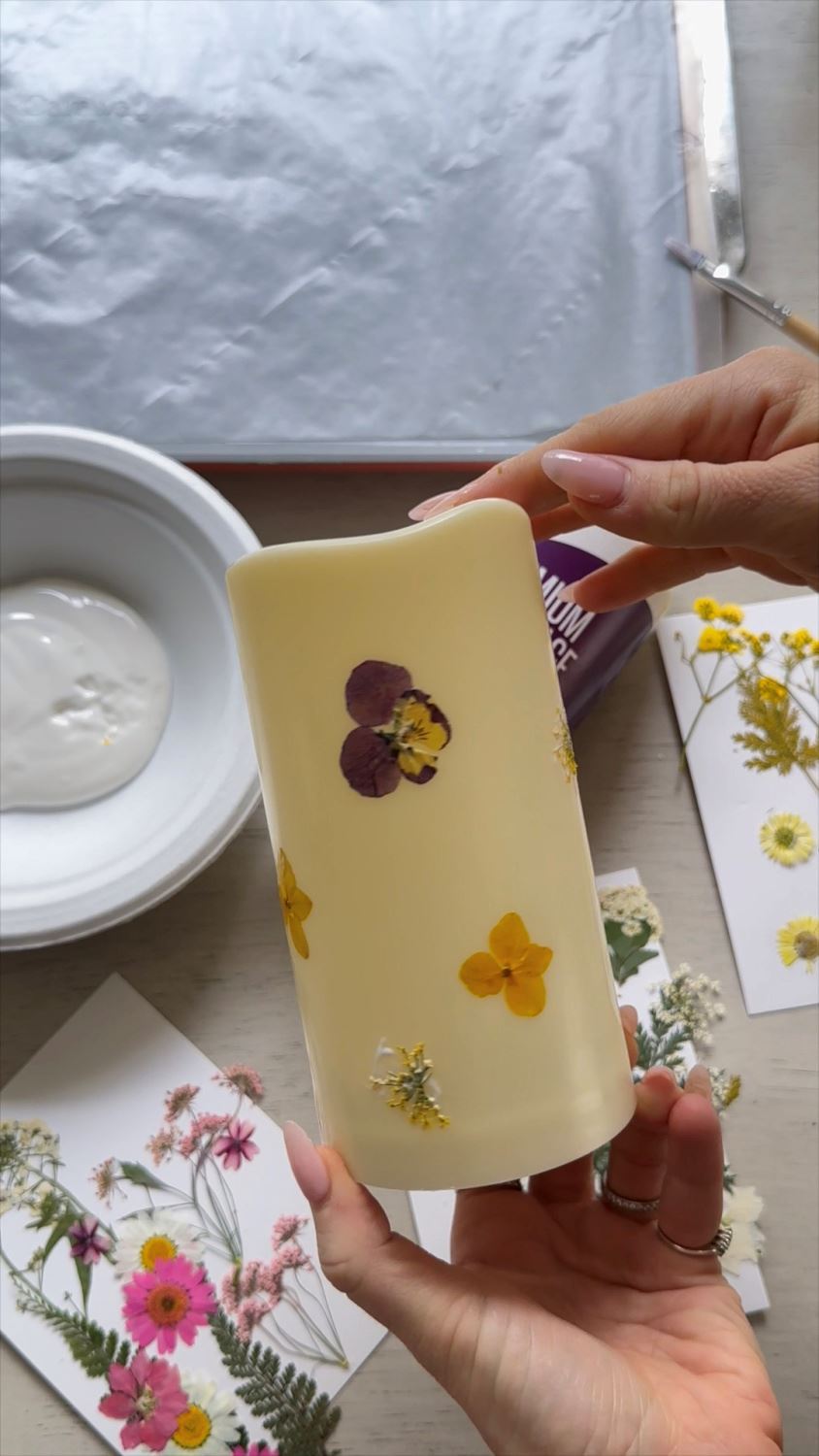 Step 4 Continue adding flowers to candle