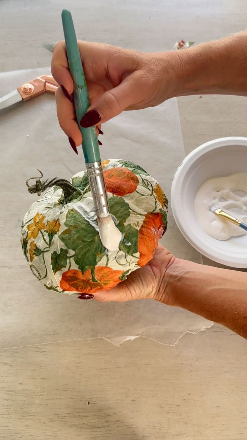 Seal the pumpkin with decoupage glue