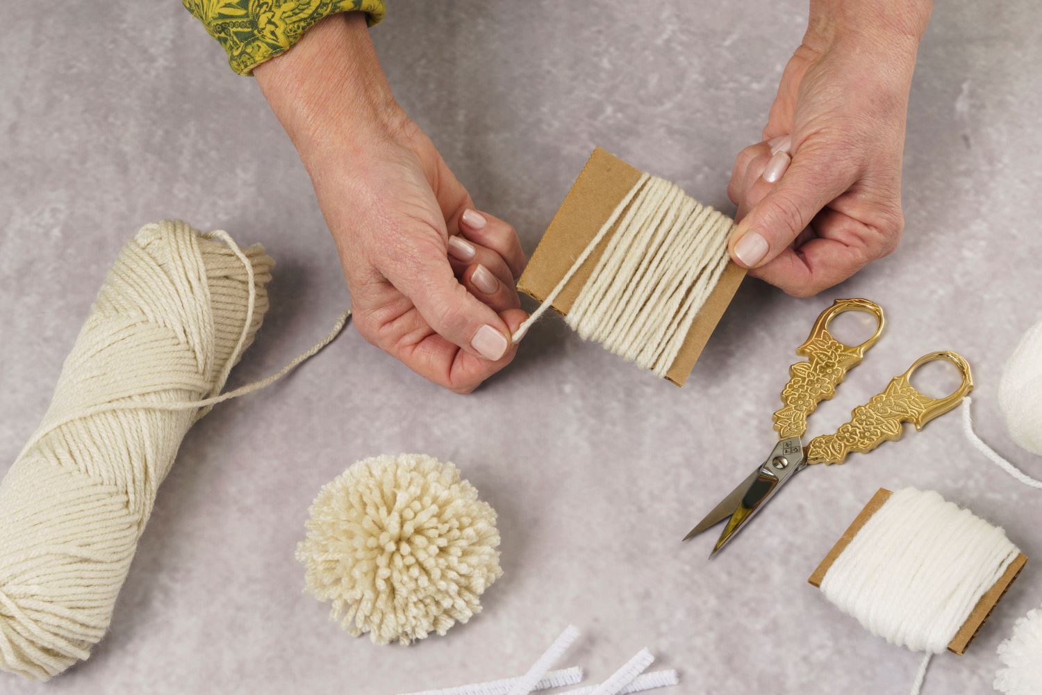 Wrap and cut the yarn to create your own pom poms