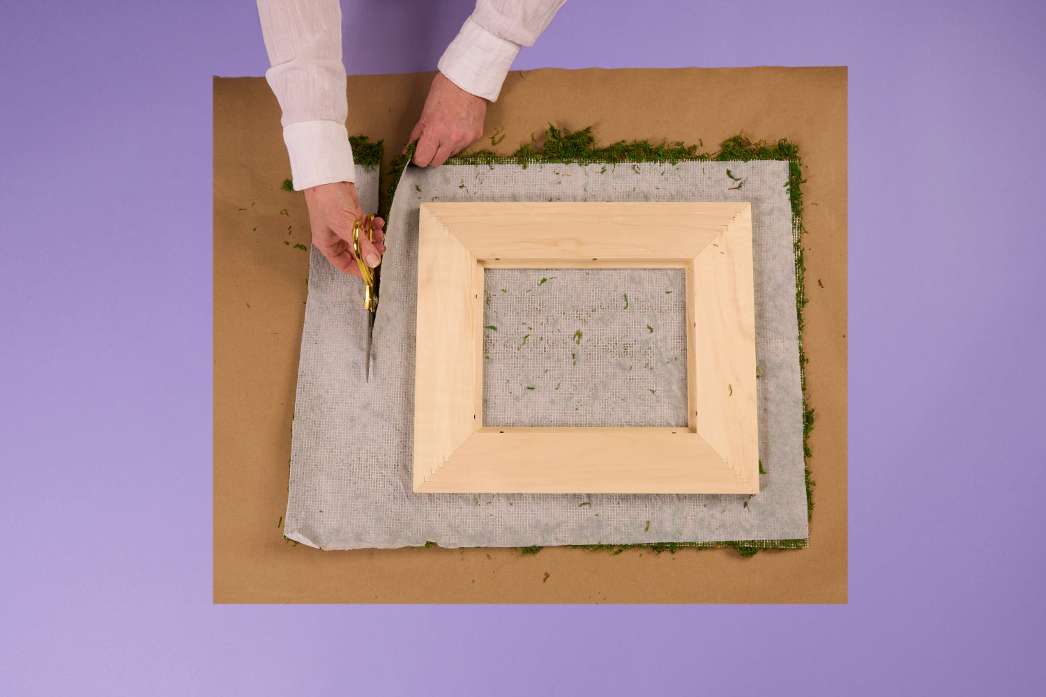 Trim the moss mat 2-3 inches larger than the frame