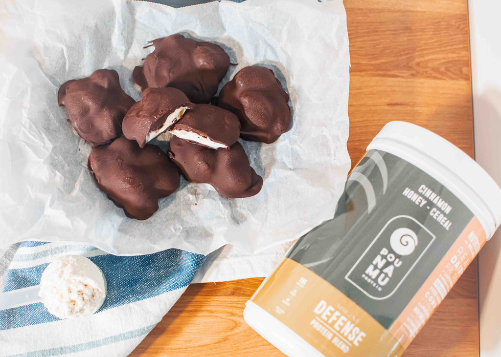 Banana yogurt clusters covered in chocolate with pounamu protein powder container