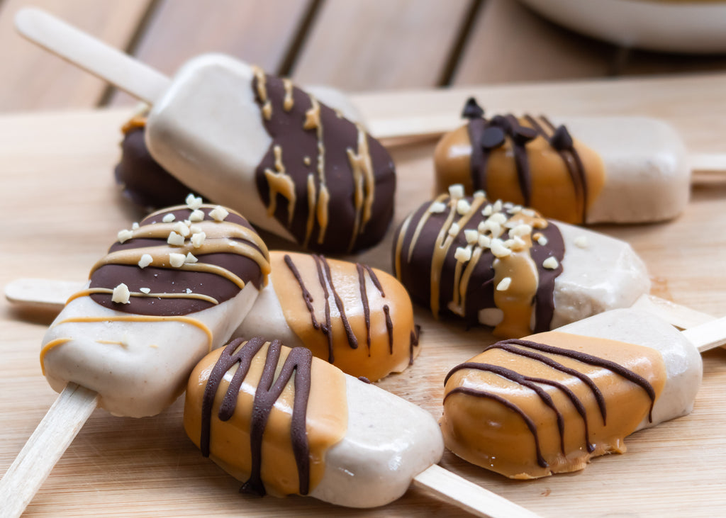 Banana protein popsicles dipped in chocolate and peanut butter 
