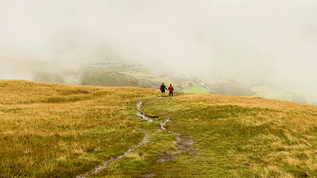 Pounamu staffer Alison hiking with fiancé through green fields in the UK