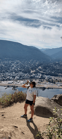 Pounamu staffer Naomi staying hydrated on the top of Pulpit rock in Nelson, BC, Canada
