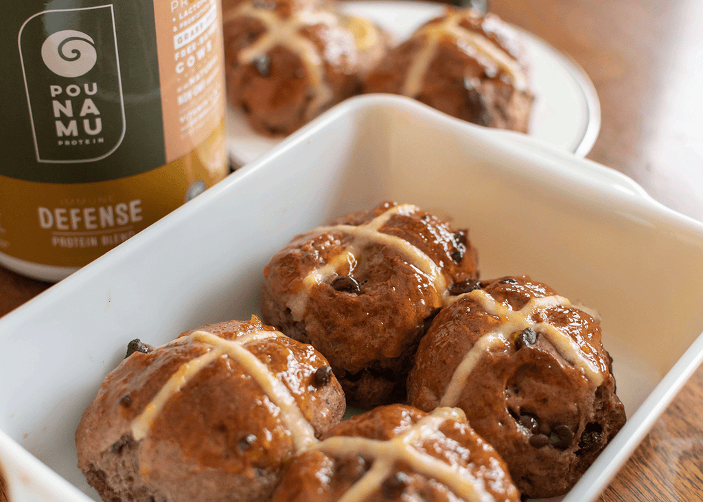 Freshly baked protein hot cross buns with chocolate chips. Made using Pounamu Protein Cinnamon, Honey and Cereal Immune Defense Blend.