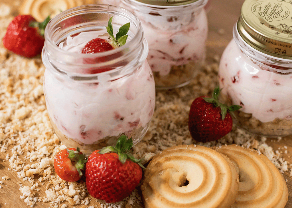Pounamu Protein Strawberry Cheesecake in glass jars with fresh strawberries