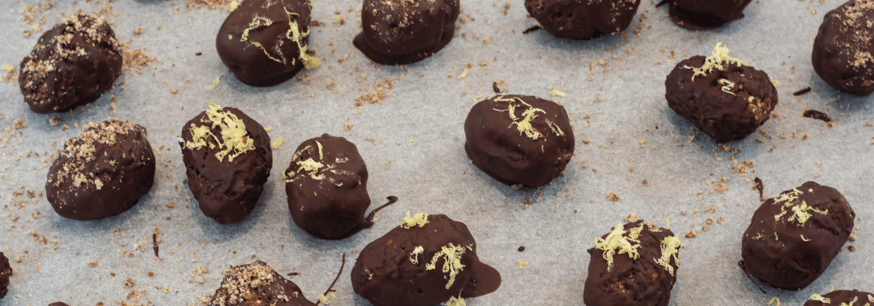 Tray of chocolate covered easter eggs with LSA or lemonzest sprinkled on top of the eggs.