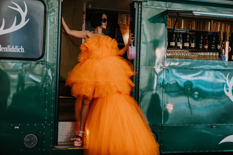 Street style woman in orange tulle dress and platform shoes at the Australian Afterpay Fashion Week 2022