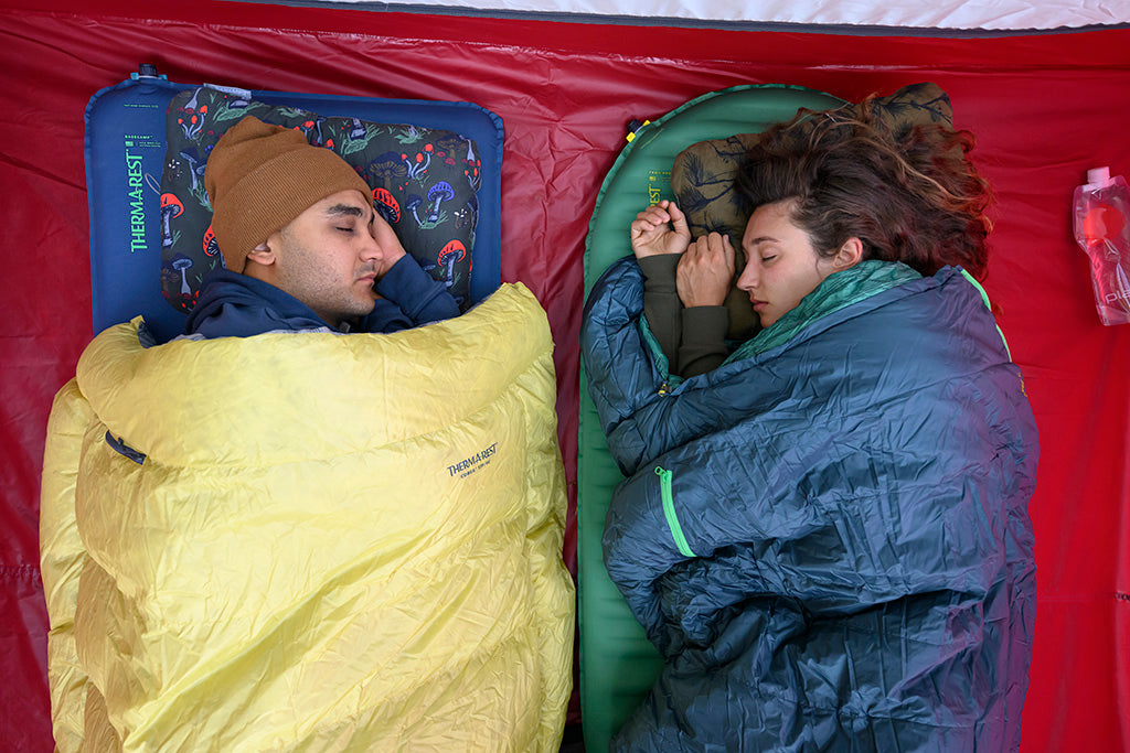 camping with pillows, bags, and pads